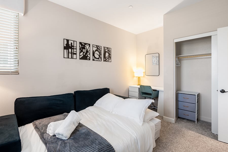 Multi-use room with queen sofa bed and workspace potential