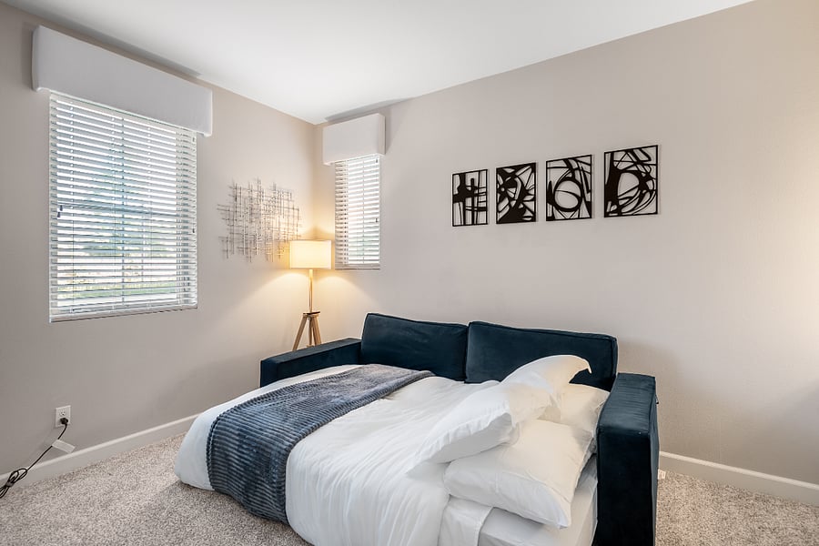Multi-use room with queen sofa bed and workspace potential