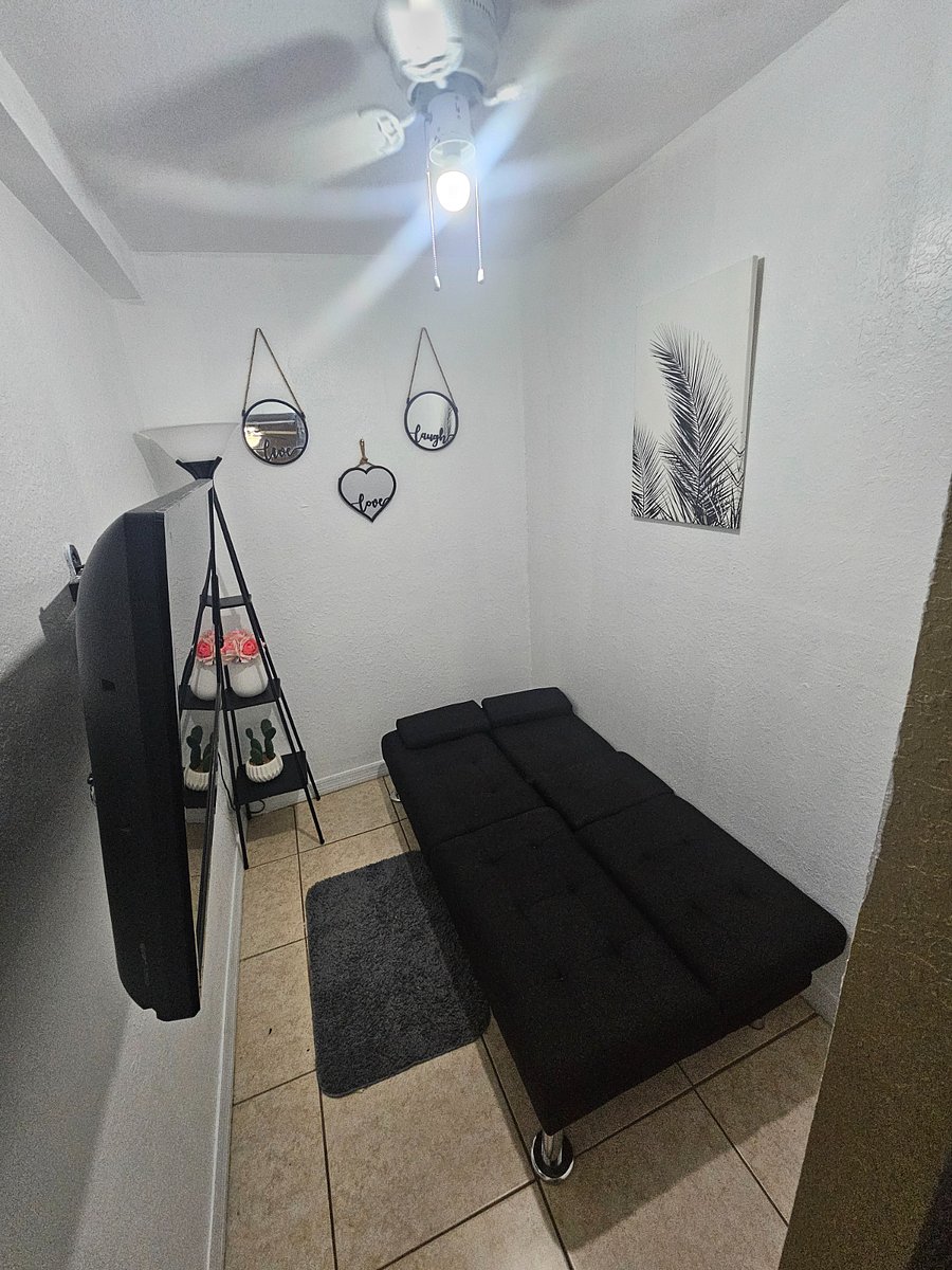Small spare room 7ft x 5.5 ft = 38.5 sq.ft. Comes with a small 32 in smart TV, and a foldable futon twin bed (39"x75")