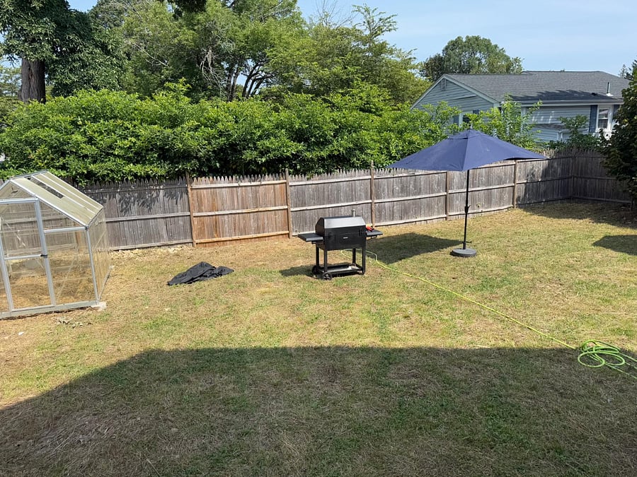 Backyard with grill and umbrella, more outdoor seating not available.