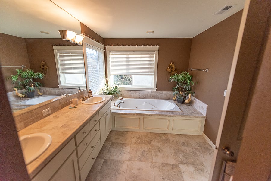 Master bathroom with double sinks and a jetted tub.