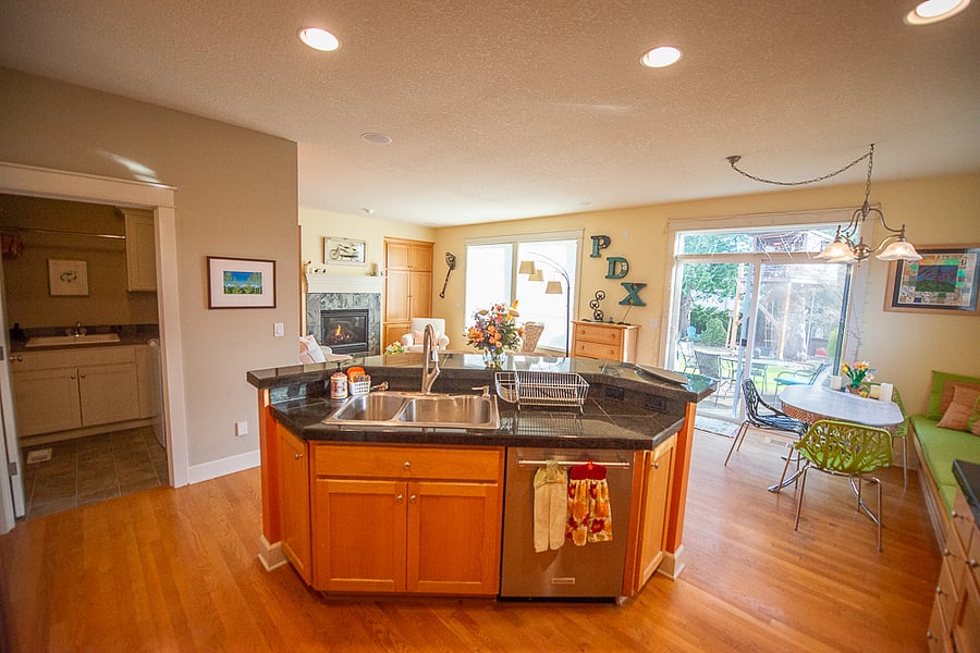 The kitchen island comes with a bar from which onlookers can entertain the chef.