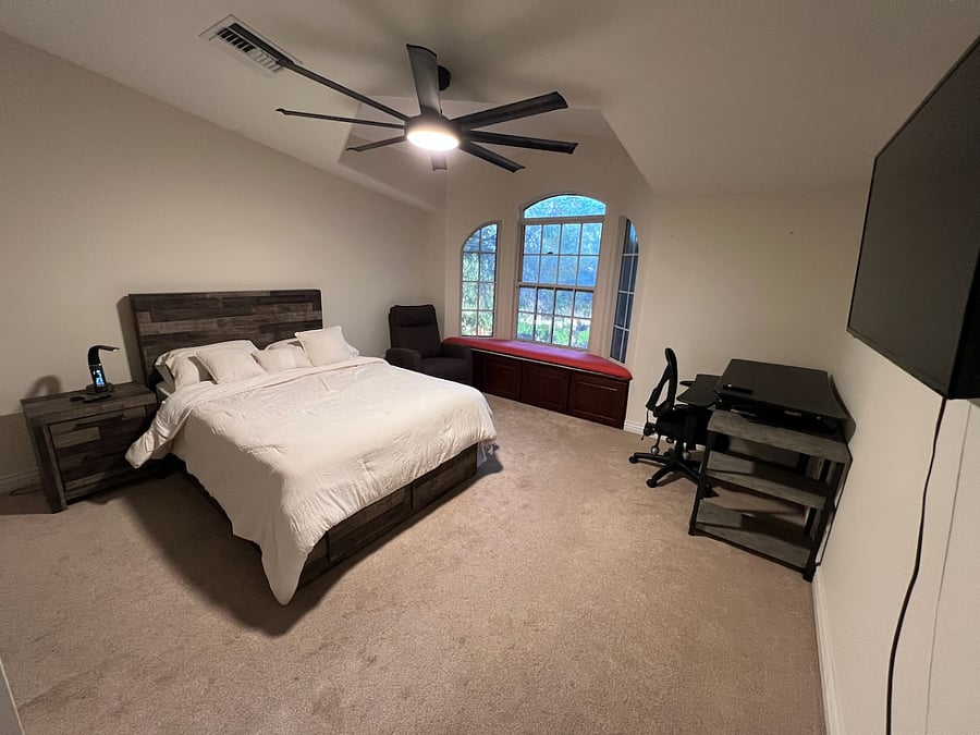 3rd bedroom with recliner and stand up desk. 