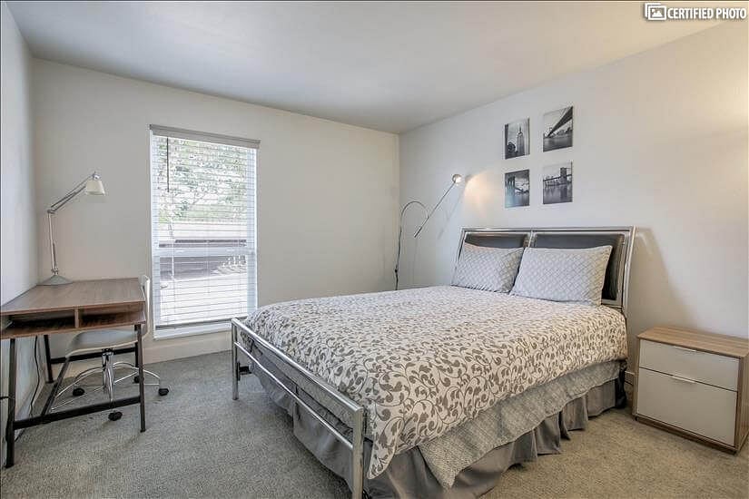 Guest bedroom with desk, chair and lamp for remote work and study