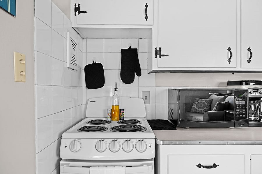 Kitchen essentials include a 1 Qt and 2 Qt saucepan (both with lids), 4 Qt Dutch oven, 8 skillet, grater, strainer, baking sheet, casserole dish, oven mitts, measuring cups/spoons, tongs, whisk, ice tray, plus salt, pepper, and avocado oil.