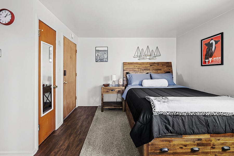 Closet with hangers, a couple of reusable grocery bags, and a full-length mirror, all thoughtfully placed near the front door for your convenience.