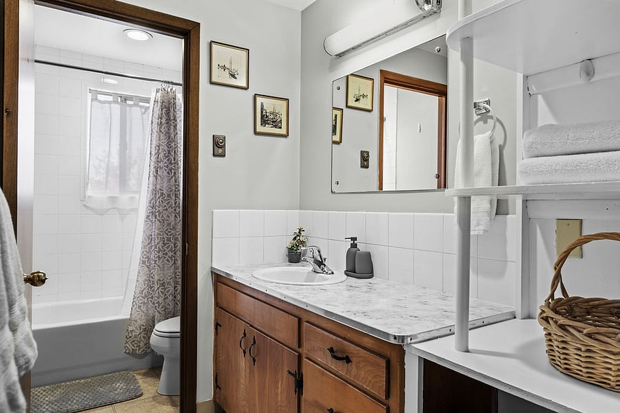Bathroom stocked with 4 bath towels, 2 hand towels, 2 washcloths, 2 makeup towels, hand soap, and a toothbrush holder for a comfortable stay.