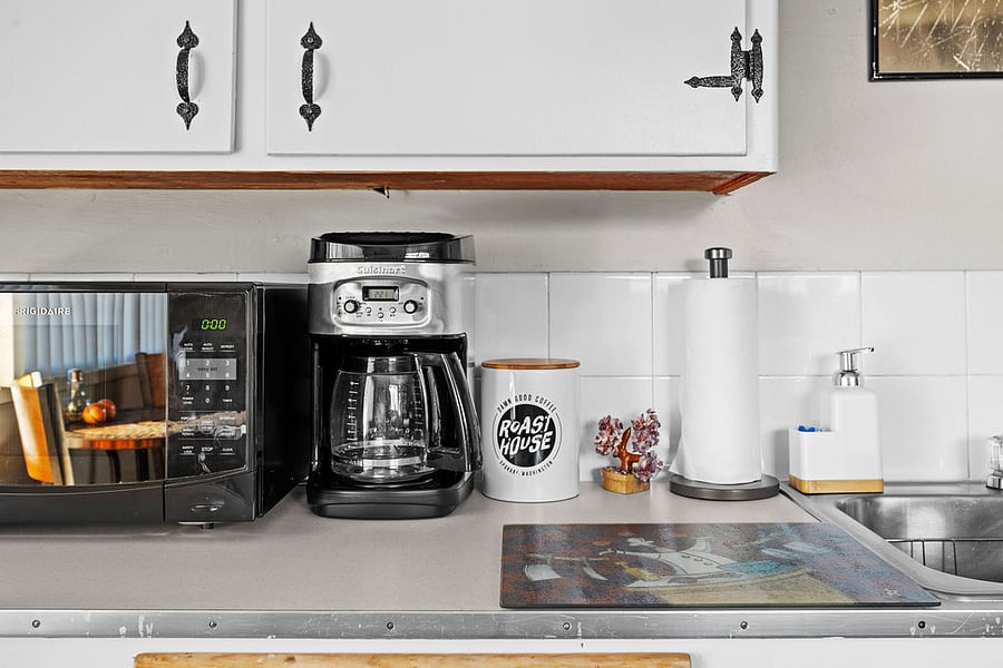 Fully stocked kitchen includes coffee for those early mornings, tea, wine opener, can opener, veggie peeler, solid and slotted turners, solid and slotted spoons, cutting boards, knife set, electric kettle, toaster, 12-cup coffee maker, and microwave.