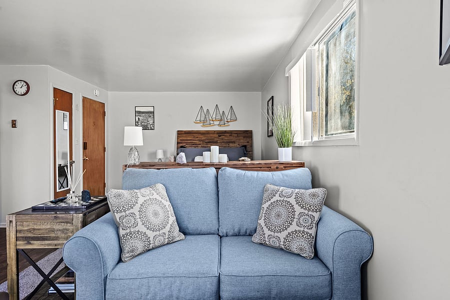 Love seat bathed in ample afternoon light, perfect for relaxing and catching your favorite show.
