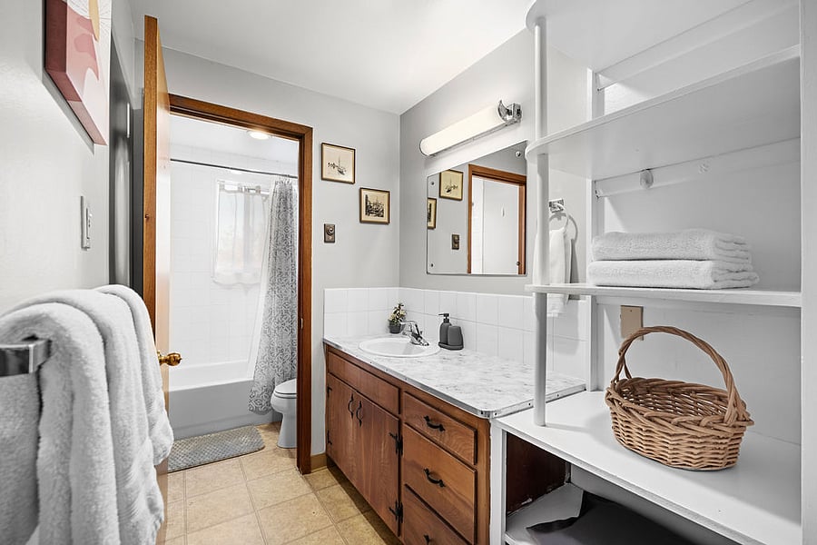 Full bathroom with a pocket door and separate door for the tub and toilet, providing extra privacy and convenience.