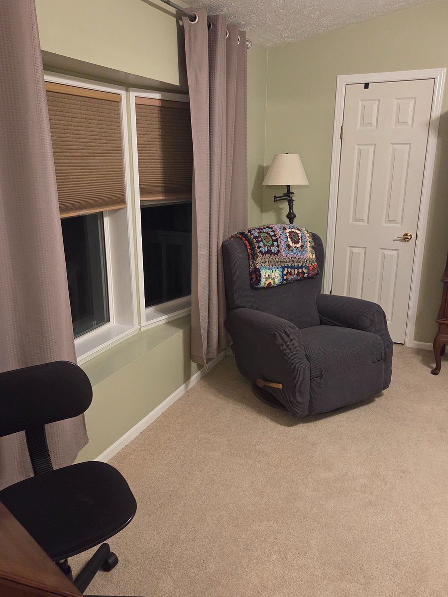 Furnished bedroom includes recliner.
Through that door is a walk-in closet.
