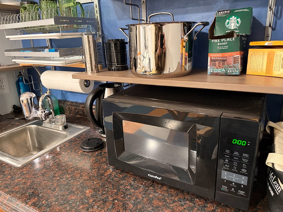 Kitchenette includes microwave, fridge, induction stove, cookware, etc.