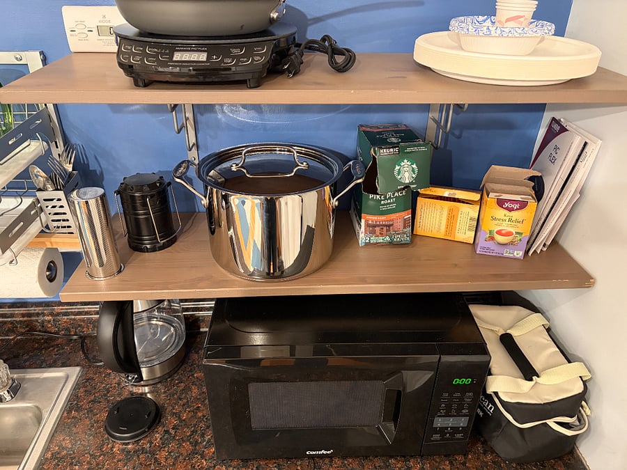 Kitchenette includes microwave, fridge, induction stove, cookware, etc.