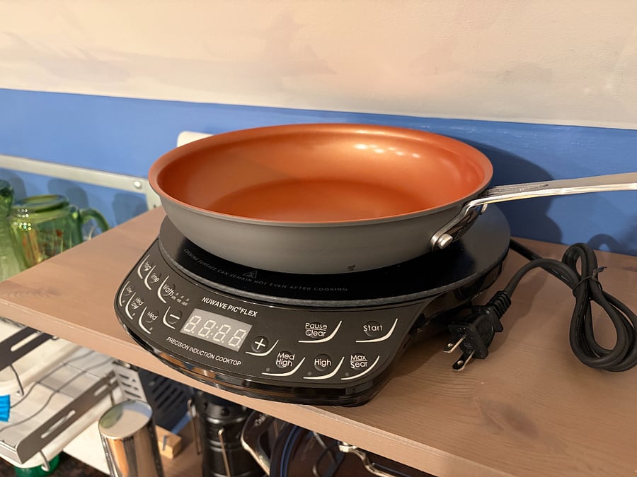 Kitchenette includes microwave, fridge, induction stove, cookware, etc.