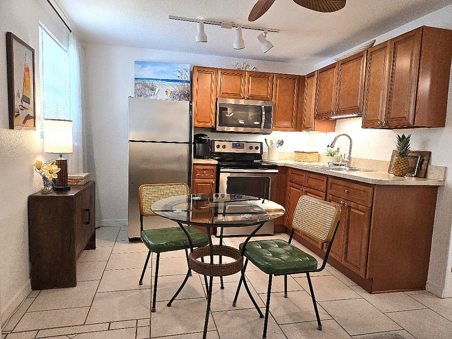 Fully equipped kitchen with stainless steel appliances and dining for two