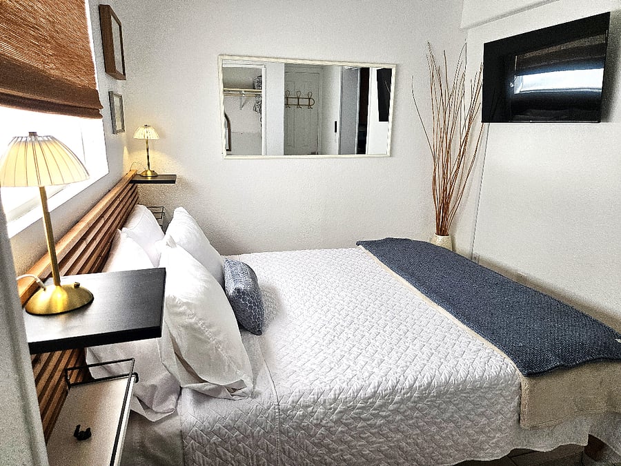 Cozy queen bedroom with new memory foam mattress, soft bedding, and Smart TV