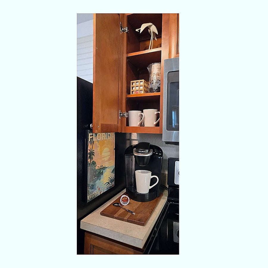 Fully stocked coffee station featuring a Keurig and complimentary starter supplies