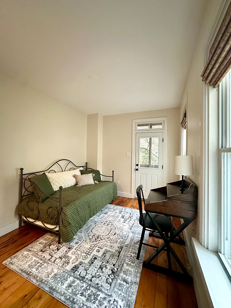office or 3rd bedroom with desk and daybed. Exterior door leads to screened balcony