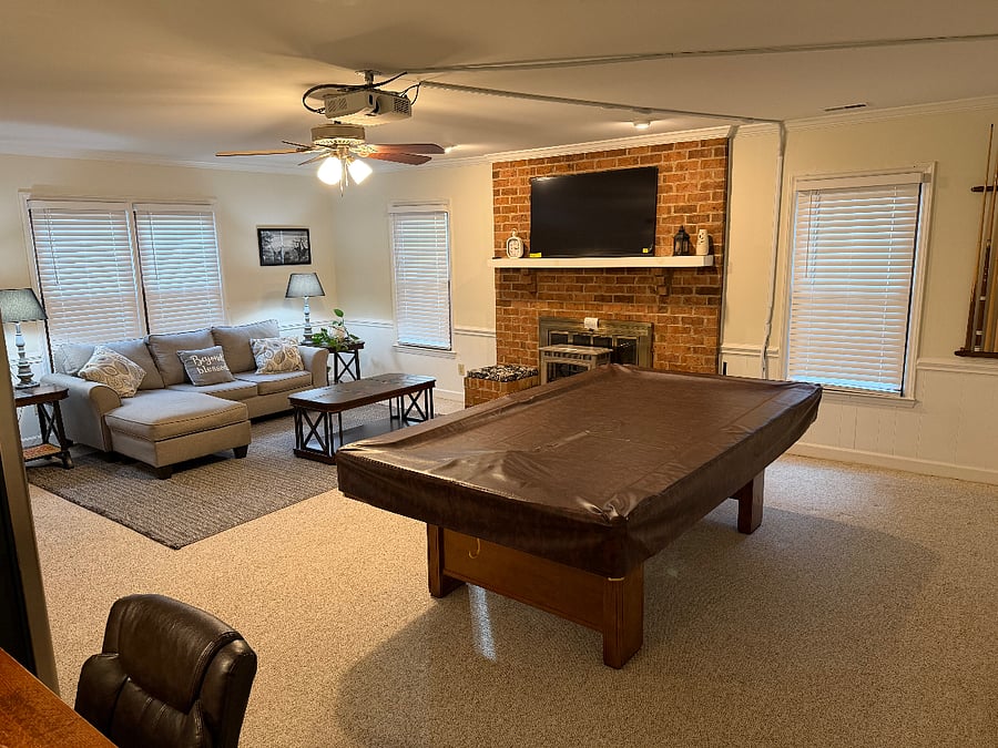 Living space with pool table and writing desk.