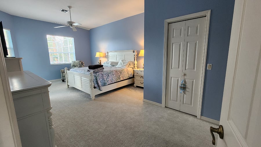 Spacious and Luxurious Primary Suite with Beautiful King Size Bedroom set including Tall Chest of Drawers, Triple Dresser with Mirror, Large Nightstands, Power Reclining Chair, and Private Access to the Screened Enclosed Lanai and Pool.