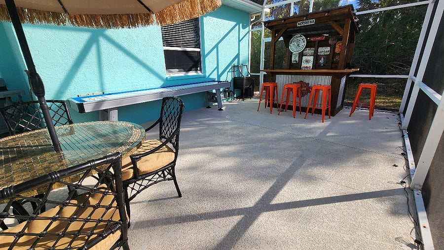 Fun and Spacious Screened Pool area with Bar, Dining, and Shuffleboard Table for endless entertainment!