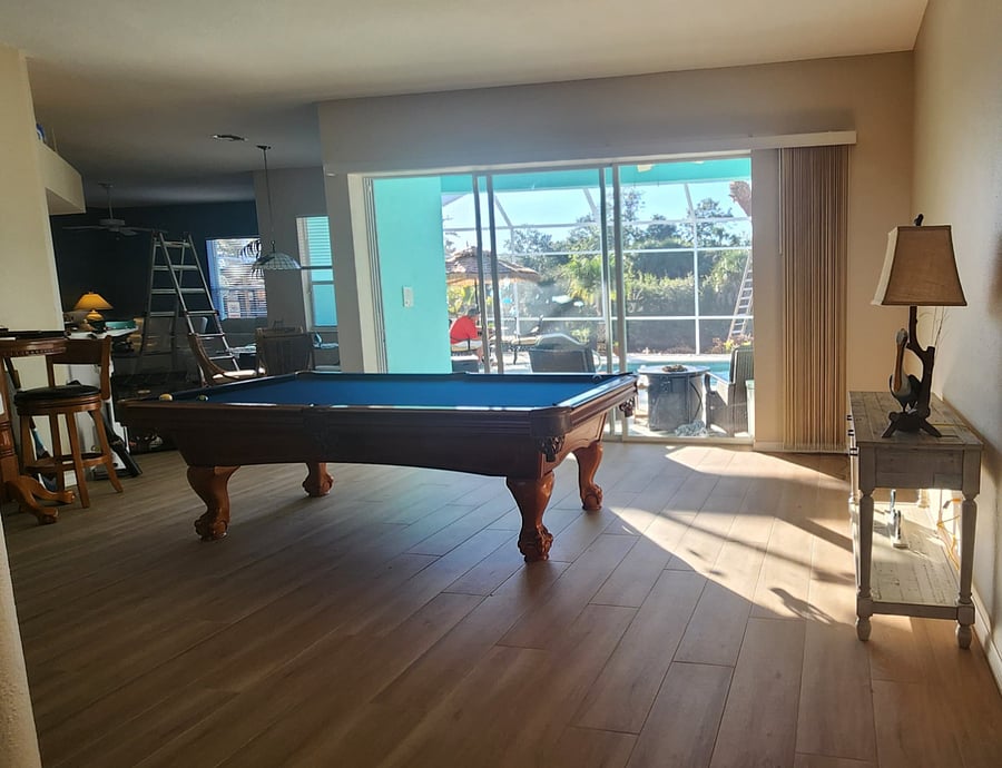 Wide Open Game Room with a 3 Door Slider to the Lanai. Pub Table with 2 Barstools, Pool Table and a New wall mounted, 65" Smart TV (not photo'd) are all in the spacious game room.