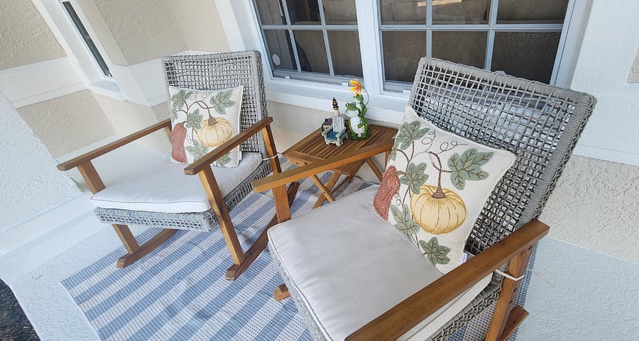 Comfy and Relaxing Front Porch with Beautiful Coastal Rocking Chairs and Side Table.