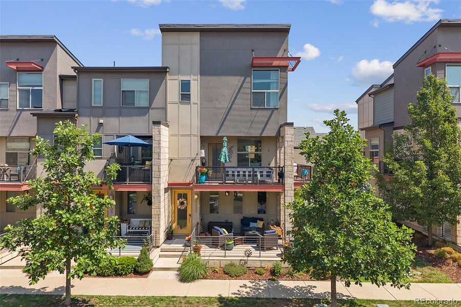 Exterior front with two outdoor living spaces