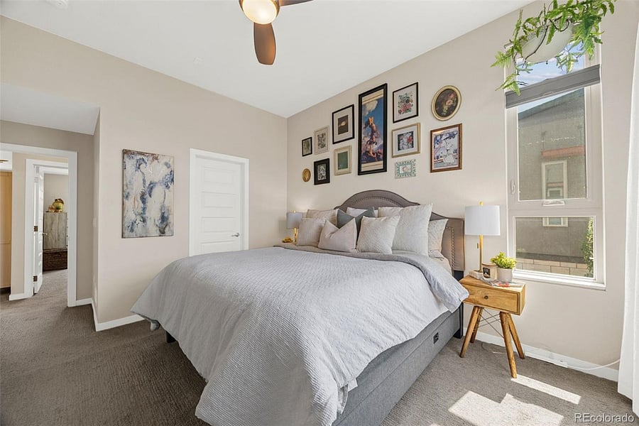 Large bedroom with King bed with vaulted ceiling and corner windows