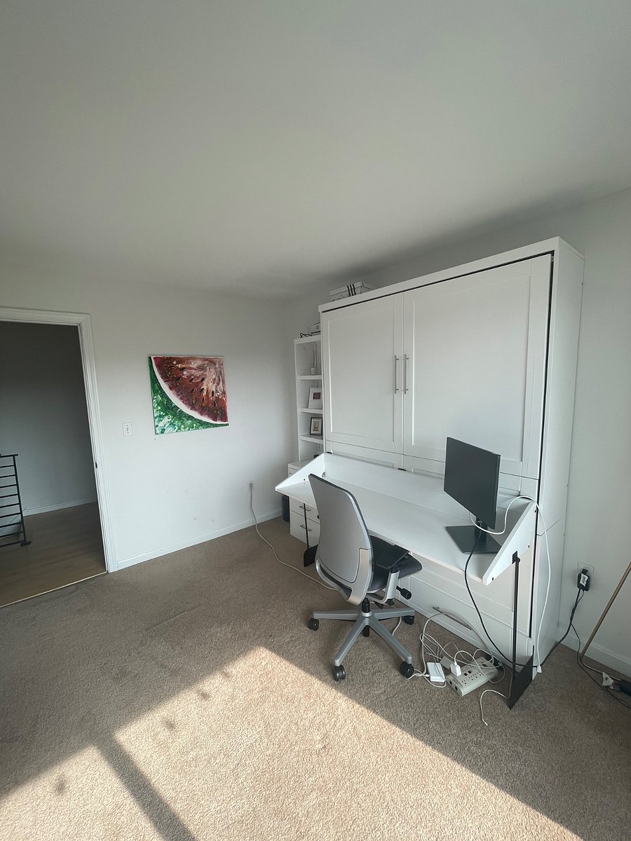 Smaller bedroom with Murphy bed that is also a desk
