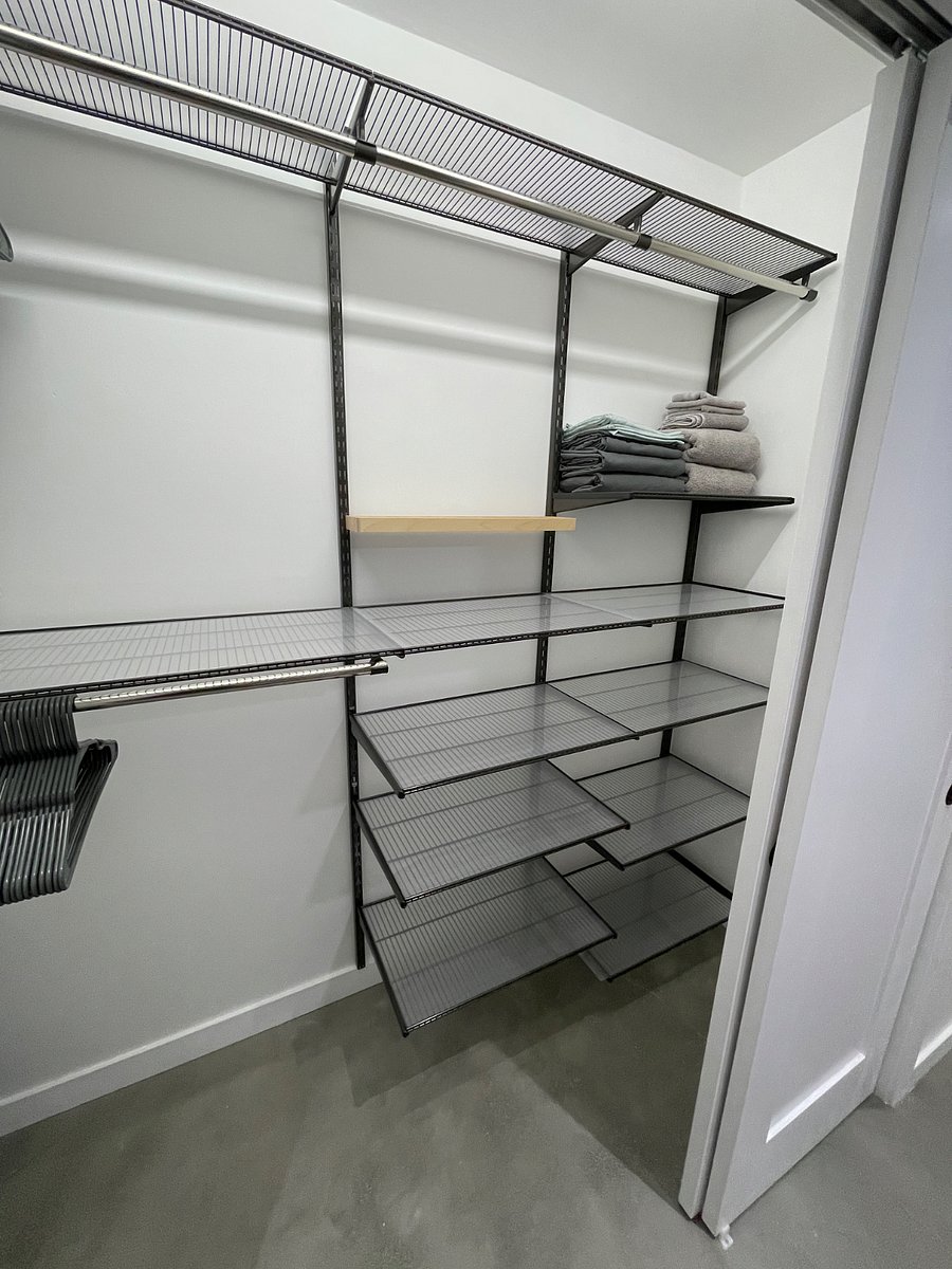 Walk in closet with ELFA storage system.