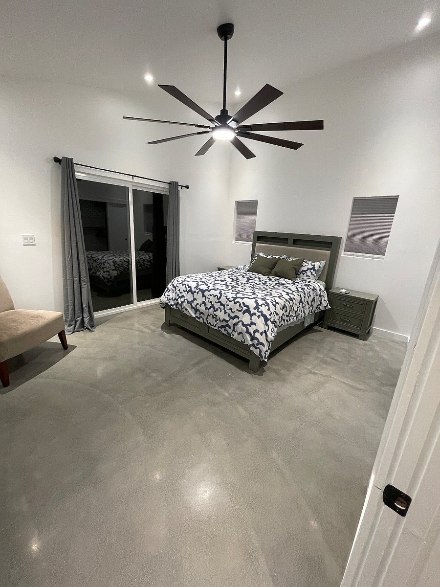 Bedroom with queen bed and smart TV.