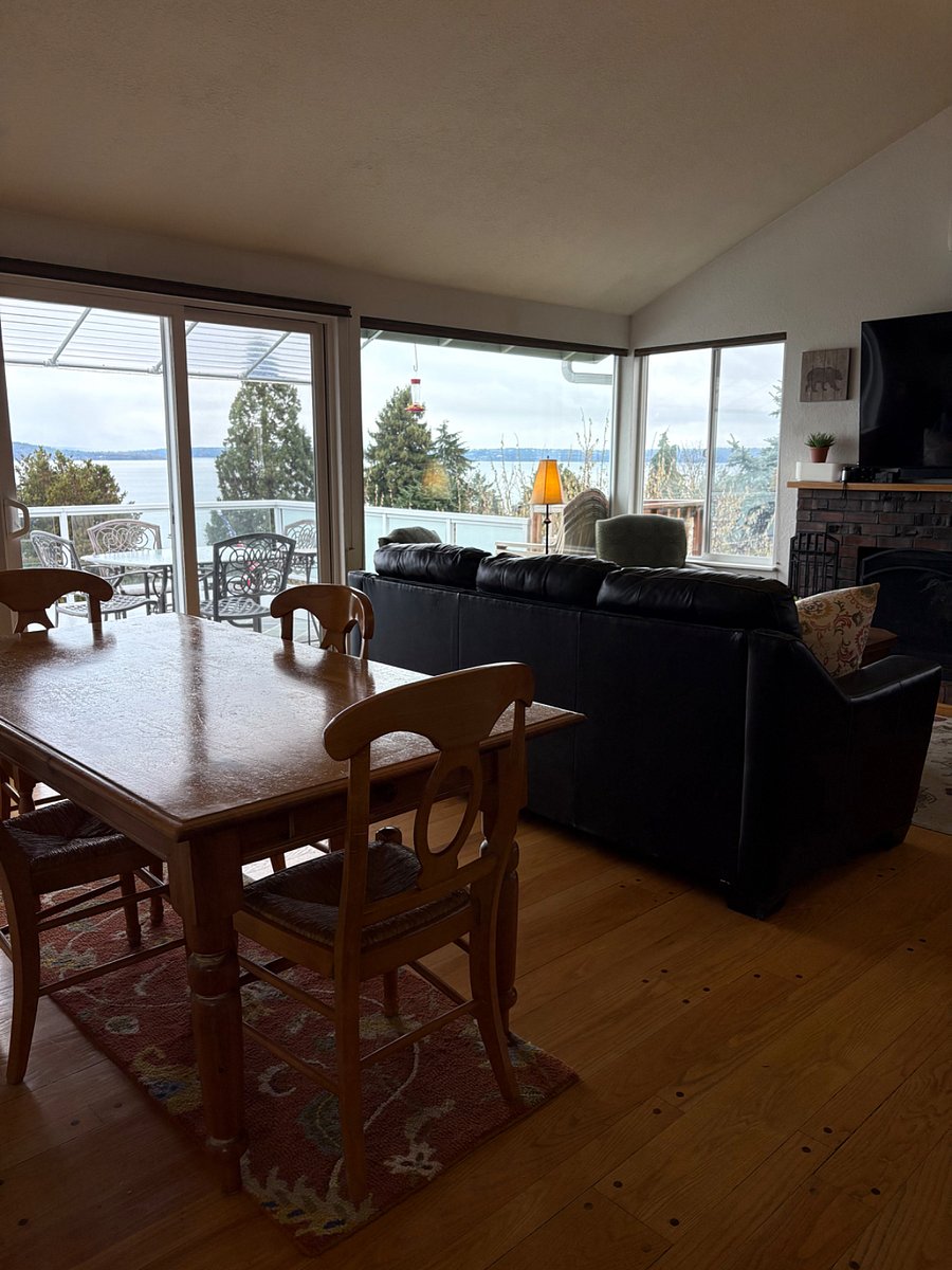 Comfortable living and dining area. 60 inch wall mounted tv in living area.