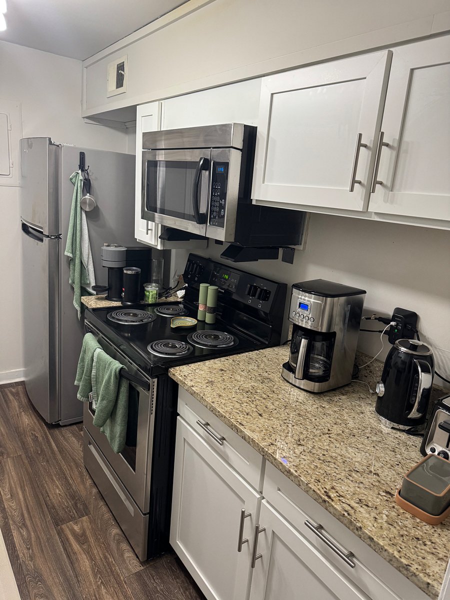 kitchen that is fully stocked with coffee maker, pots& pans, etc