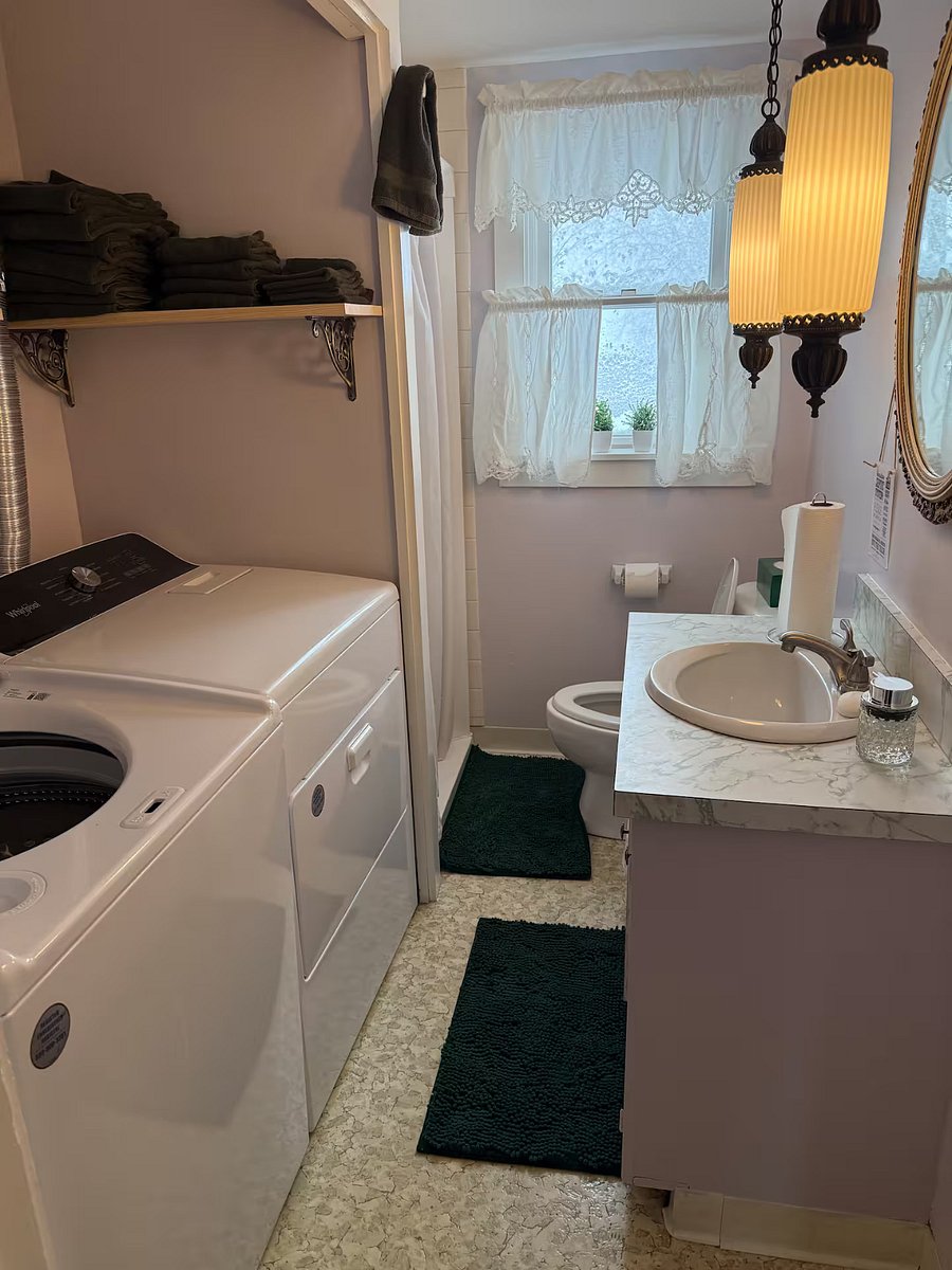 First floor bathroom with standup shower and washer/dryer.