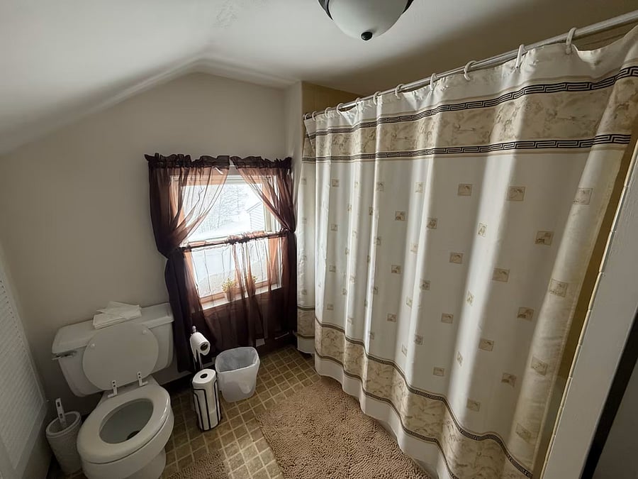 Second floor bathroom with shower and bath tub.