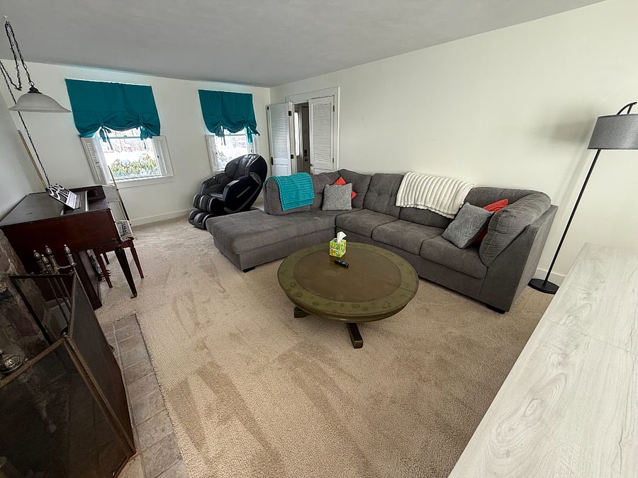 Large living room with 65" Roku Smart TV. 