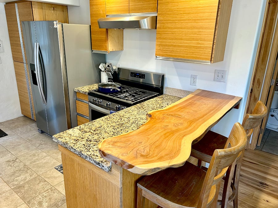 Live-edge juniper wood kitchen bar counter.