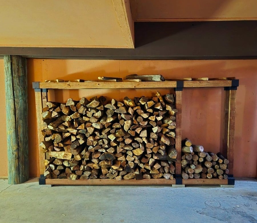 Sturdy rack outside is stocked with seasoned wood.