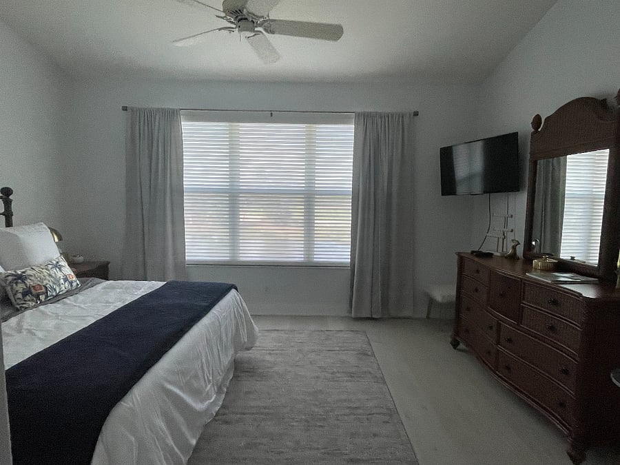 Bright and spacious MBR features a water view, vaulted ceilings, ceiling fan, large walk-in closet and TV