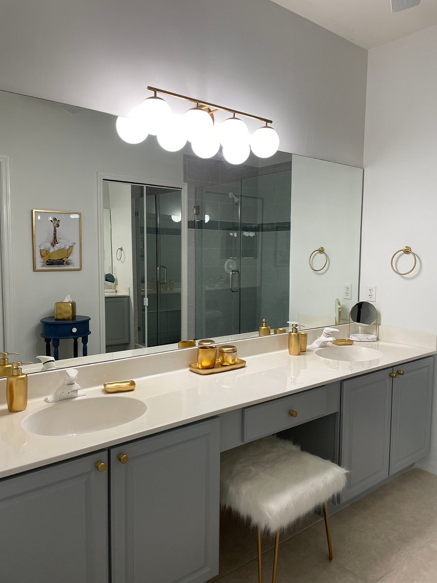 Primary bathroom features double sinks and a large shower with bench.