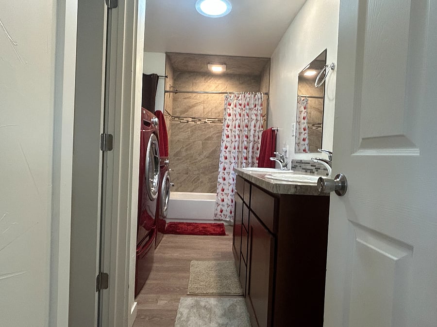 Huge, full bathroom with double vanity, shower, private water closet, and full size clothes washer and dryer