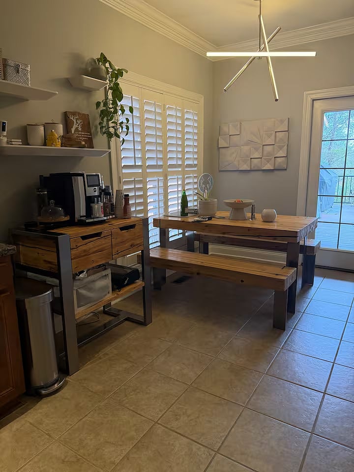 Shared coffee and dining area with espresso machine, seating, and access to outdoor deck
