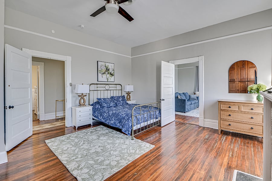Master Bedroom with Queen bed, wall of storage, tv and dresser