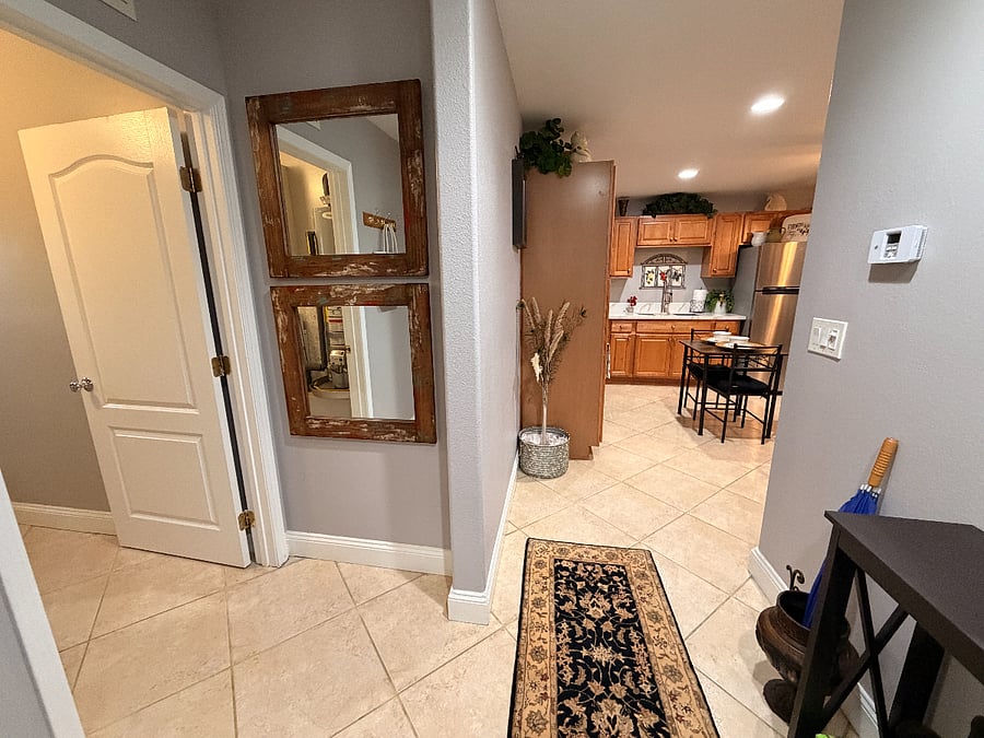 View from the entrance.  Left side (unseen) door to restrrom, left side (door seen) entrance to laundry room and kitchen in foreground.