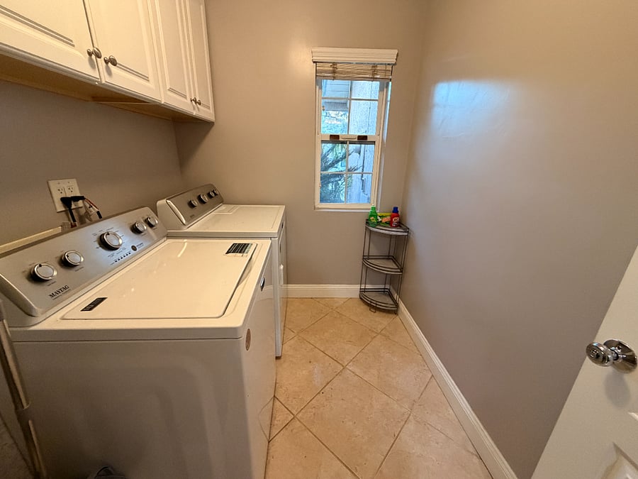 In-unit laundry room with cabinet space