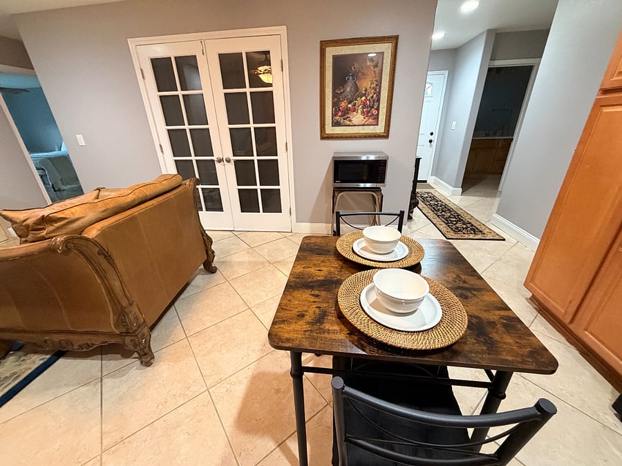 Dining area looking out to one of the bedrooms and front door/bathroom door.
