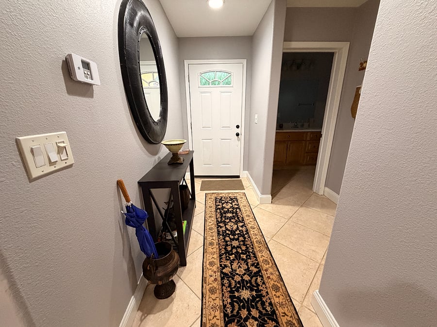 front door hallway with bathroom door seen on right side