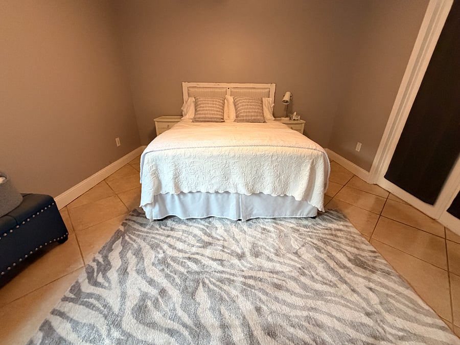 Bedroom 1 off kitchen area (french doors) and also has additional door entrance on other side of room.