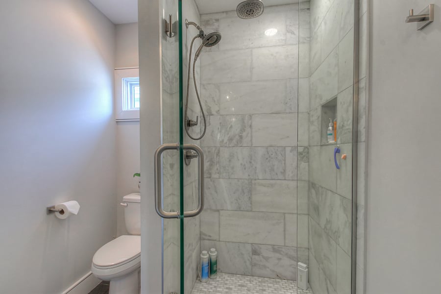 Marble & tile walk-in shower with a Rain Shower Head - you'll have the essentials all ready for you :)